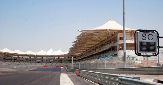 Losail International Circuit grandstand and track, SC safety car sign visible.